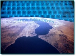 satellite image of part of the world, with glowing blue computer keyboard in background and words Lamar Public Library