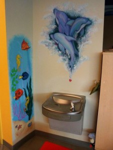 sea life and fairy murals at the water fountain